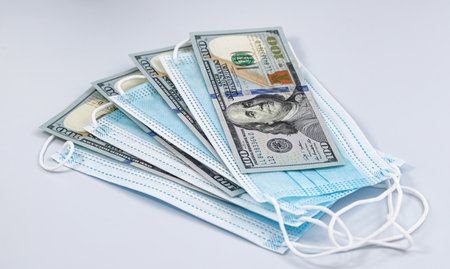 Protective disposable breathing masks and hundred-dollar billsの写真素材