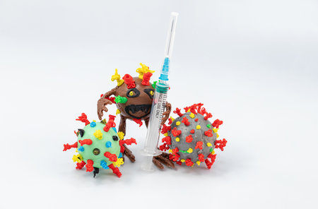 Monster virus is holding a syringe surrounded by other virusesの写真素材