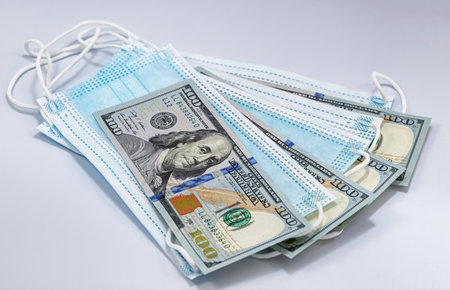 Protective disposable breathing masks and hundred-dollar billsの写真素材