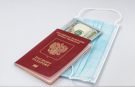 Protective medical masks, dollars and passportの写真素材