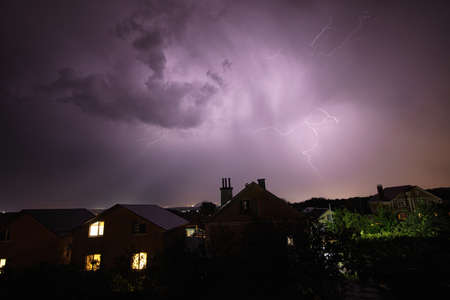 A flash of lightning against the evening sky and mountain rangesの写真素材