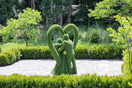 ZHELEZNOVODSK - JULY 04: Landscape sculpture dedicated to wedding day - bride and groom stand in symbol of heart. July 04, 2021 in Zheleznovodsk, Russia.のeditorial素材