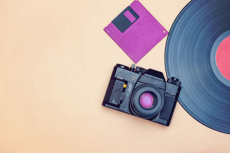 An old vinyl record, a film camera and a floppy disk for a computer are reminder of the rapid progress in the field of high technologiesの写真素材