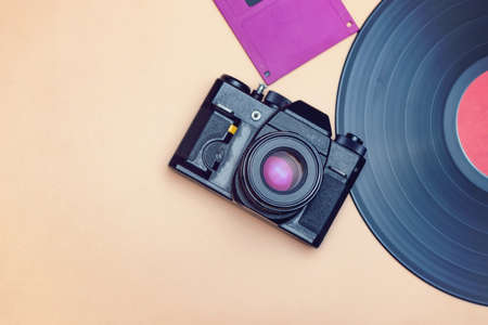An old vinyl record, a film camera and a floppy disk for a computer are reminder of the rapid progress in the field of high technologiesの写真素材