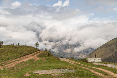 Landscape-view from the mountain to the clouds creeping in the valley