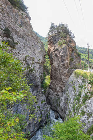 A small fast mountain river flows in a mountain gorgeの写真素材