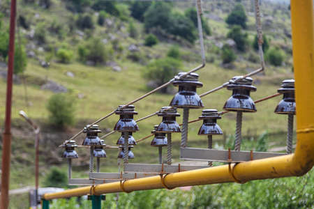A small power line is laid directly through a gas pipe leading to a mountain villageの写真素材