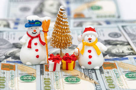 Toy Santa Claus and Snowman brought gifts under the Christmas treeの写真素材