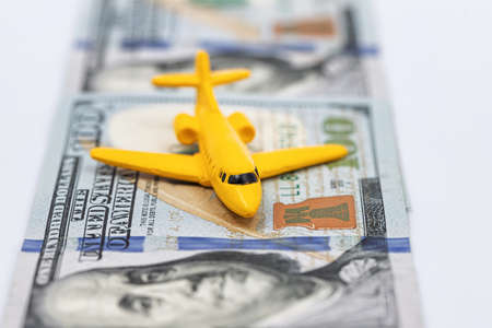 Toy plane takes off on a strip of hundred-dollar bills