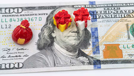 Franklin has toy models of Christmas gift boxes on the banknote instead of eyes.の写真素材