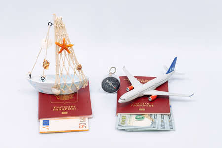 Toy airplane and boat, passports and cash dollarsの写真素材