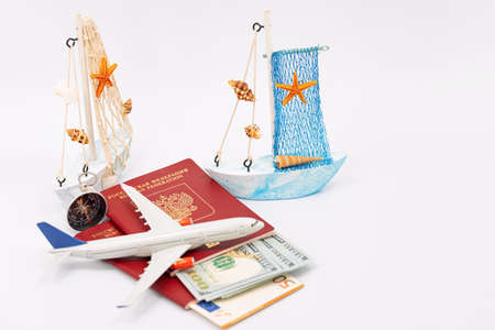 Toy airplane and boat, passports and cash dollarsの写真素材