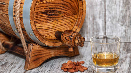 Oak barrel, roasted almonds, glass of whiskey and cigarの写真素材