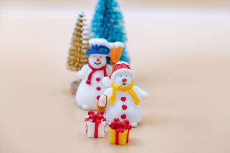 Toy figures of snowmen, Christmas tree, gifts and dollarsの写真素材