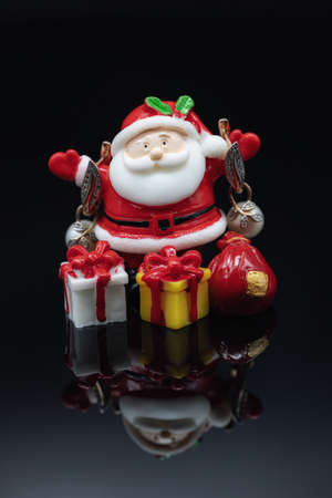 Toy Santa Claus holds gold jewelry and giftsの写真素材