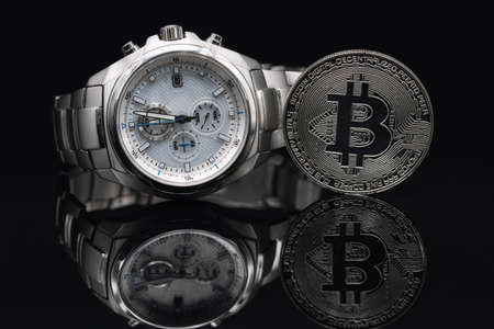 Solid men's wristwatch with a chronometer in a titanium case and a gift coin Bitcoinの写真素材