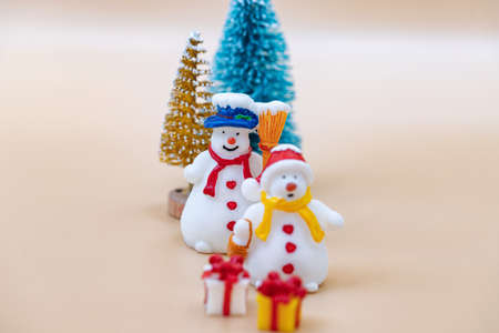 Toy figures of snowmen, Christmas tree, gifts and dollarsの写真素材