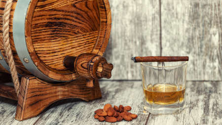 Oak barrel, roasted almonds, glass of whiskey and cigarの写真素材