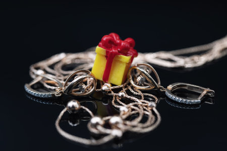 Elegant thin gold chain, earrings with movable briliant pendant and toy gift boxの写真素材