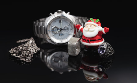 Toy Santa Claus holds gold jewelry, watch and giftsの写真素材