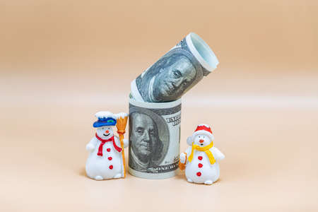 Toy figures of snowmen, Christmas tree, gifts and dollars