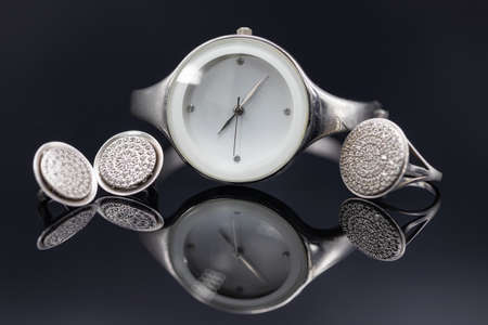Elegant womens watches in a metal case and jewelry made of silver