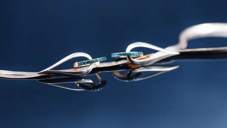 Gold earrings in the shape of a drop with emerald insertsの写真素材