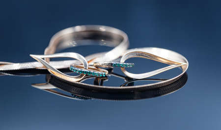 Gold earrings in the shape of a drop with emerald insertsの写真素材