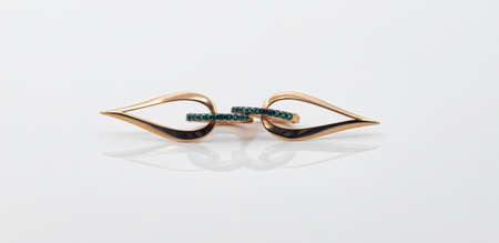 Gold earrings in the shape of a drop with emerald insertsの写真素材
