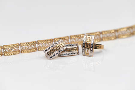 set of gold earrings and gold ringの写真素材
