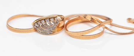 Engagement ring of gold and different weave chainの写真素材