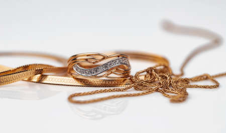 A gold ring with diamonds and a gold chain necklaceの写真素材