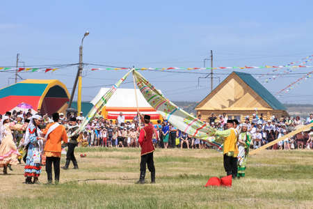 Men and women in national costumes dance traditional folk dances in celebration of the holiday Sabantuyのeditorial素材