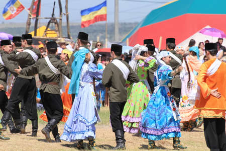 Men and women in national costumes dance traditional folk dances in celebration of the holiday Sabantuyのeditorial素材