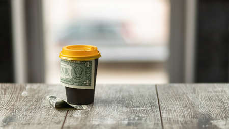 Generous tip left behind a cup of coffeeの写真素材