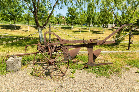 Antique metal mechanical device on wheels for agricultureの写真素材