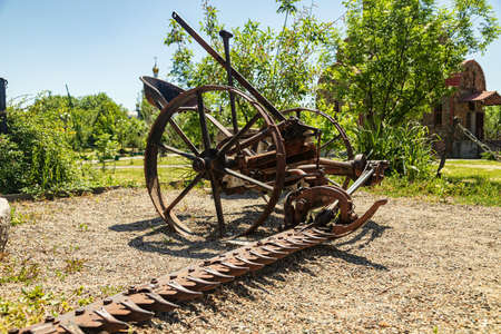 Antique metal mechanical device on wheels for agricultureの写真素材
