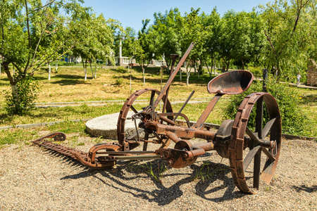 Antique metal mechanical device on wheels for agricultureの写真素材