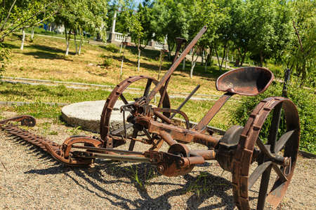 Antique metal mechanical device on wheels for agricultureの写真素材