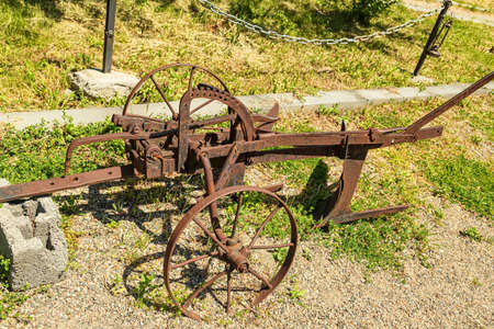 Antique metal mechanical device on wheels for agricultureの写真素材