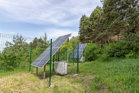 Large solar panel installed in a park area among the forestの写真素材