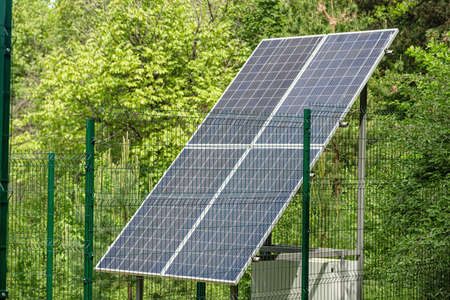 Large solar panel installed in a park area among the forest