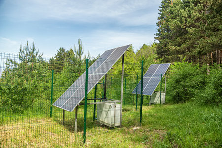 Large solar panel installed in a park area among the forestの写真素材