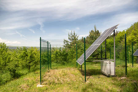 Large solar panel installed in a park area among the forestの写真素材