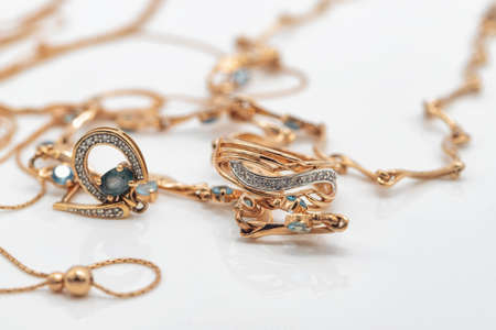 A gold chain with a pendant and a Topaz ringの写真素材