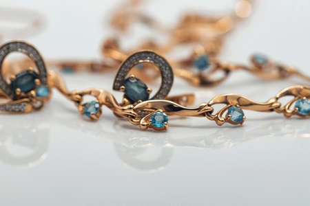 A gold chain with a pendant and a Topaz ringの写真素材
