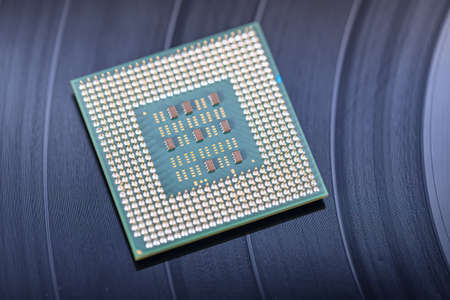 A giant leap in technology between recording on vinyl records and the creation of computer processorの写真素材