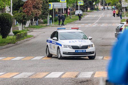 A police car blocks traffic on the street for the duration of sports competitionsのeditorial素材