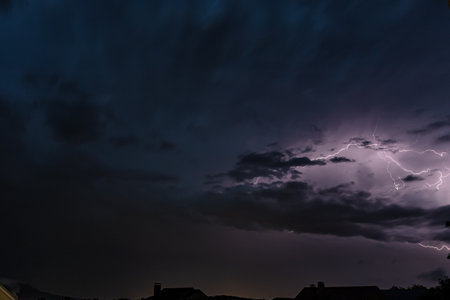 Beautiful lightning flashes in the evening sky during a thunderstormの写真素材