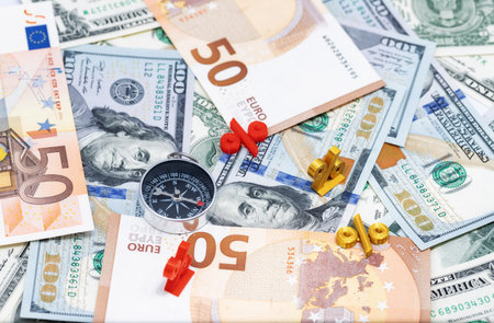 Mathematical symbols of interest lie on top of the banknotesの写真素材